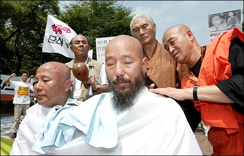 한상렬 통일연대 상임대표와 박석운 국민행동 운영위원장이 23일 오전 이라크파병 결사저지 각계 대표 10만 릴레이 단식농성장에서 삭발을 하고 있다. 